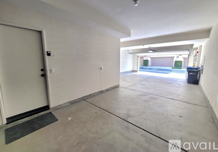 A spacious garage with a door and a mat on the floor.