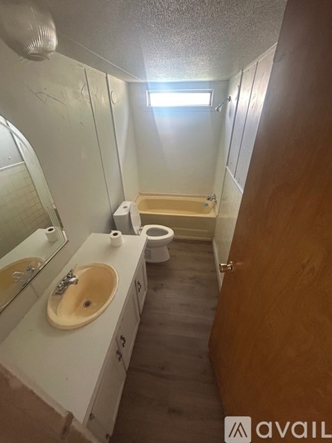 A bathroom with a sink, toilet, and bathtub.