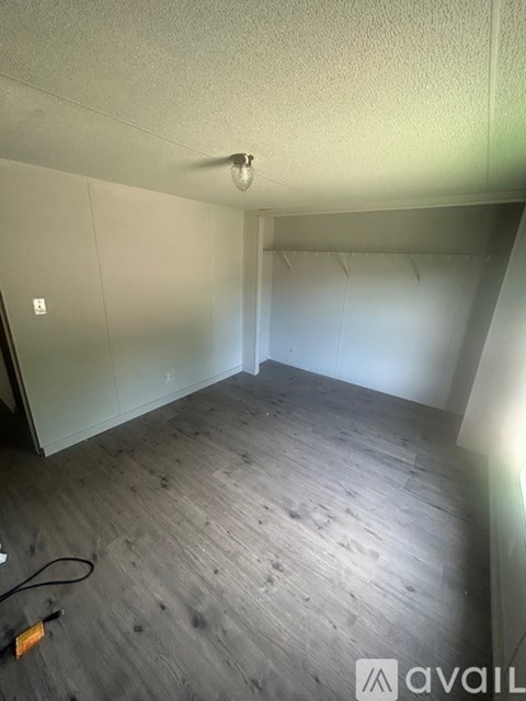 A room with wooden flooring and a white ceiling.