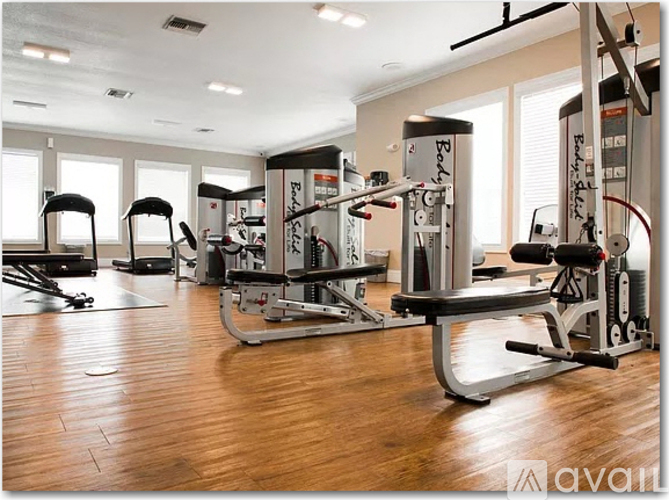 A gym with a variety of equipment including a leg press machine.