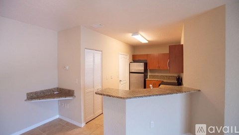A kitchen area with a counter and cabinets.