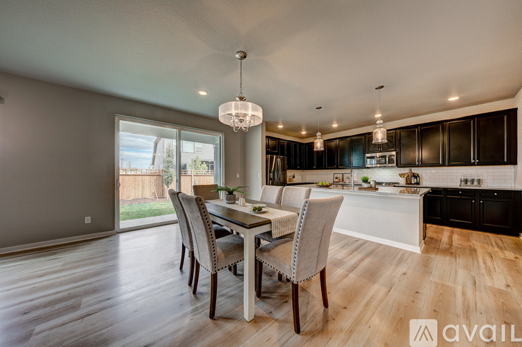 A modern kitchen with a dining table and chairs.
