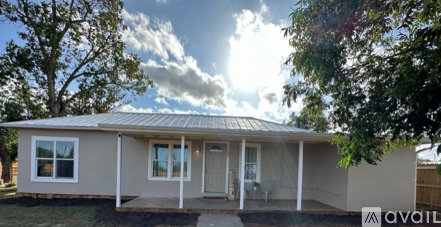 A house with a porch and a covered patio is available for rent.
