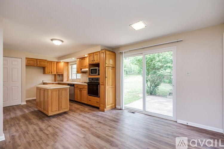 A kitchen with wooden cabinets and a white fridge.