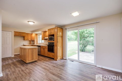 A kitchen with wooden cabinets and a white fridge.
