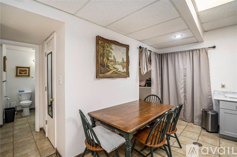 A dining area with a wooden table and chairs.