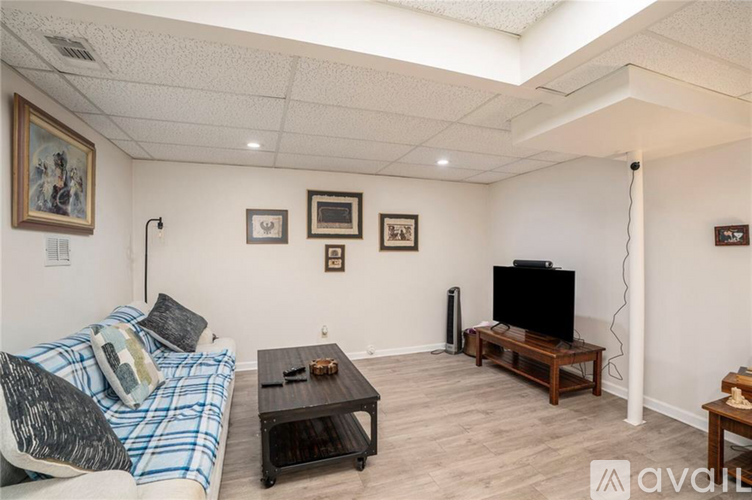 A living room with a couch, coffee table, and television.
