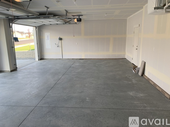 A spacious garage with a concrete floor and white walls.