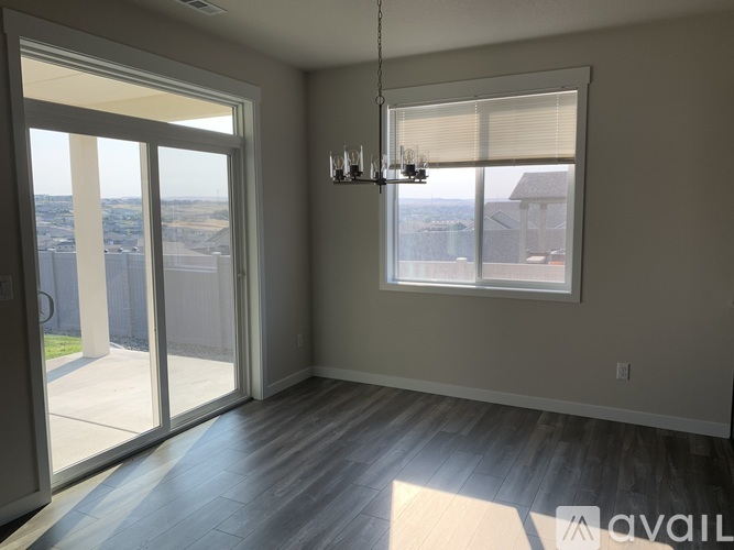 A room with a large window and sliding glass doors.