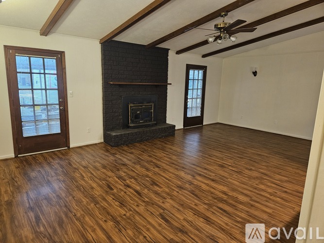 A room with wooden floors and a fireplace.
