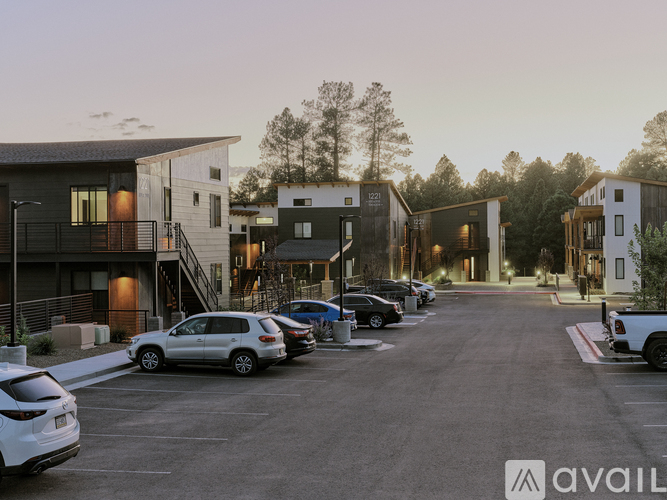 A parking lot with cars and modern buildings in the background.