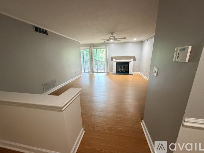 A spacious living room with a fireplace and sliding glass doors.