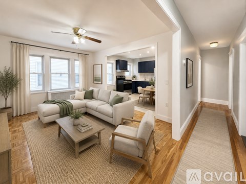 A living room with a white couch, a wooden coffee table, and a ceiling fan.