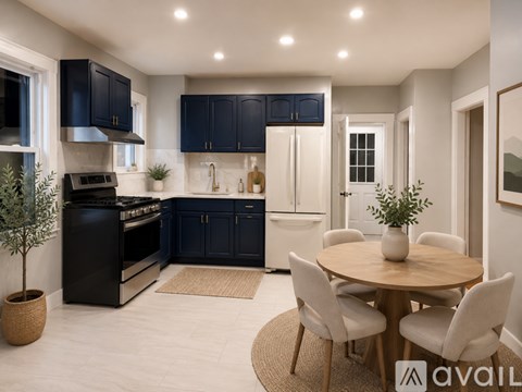 A modern kitchen with dark blue cabinets and a central island.
