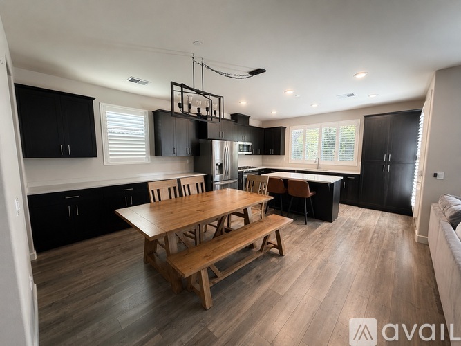 A modern kitchen with a wooden table and chairs.
