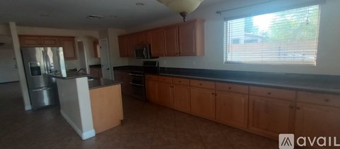 A kitchen with wooden cabinets and a white island.