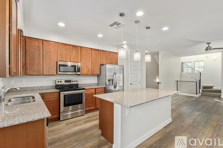 A kitchen with wooden cabinets and a granite countertop.