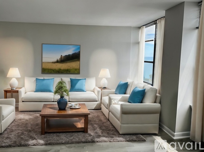 A living room with a white couch, a coffee table, and a painting on the wall.