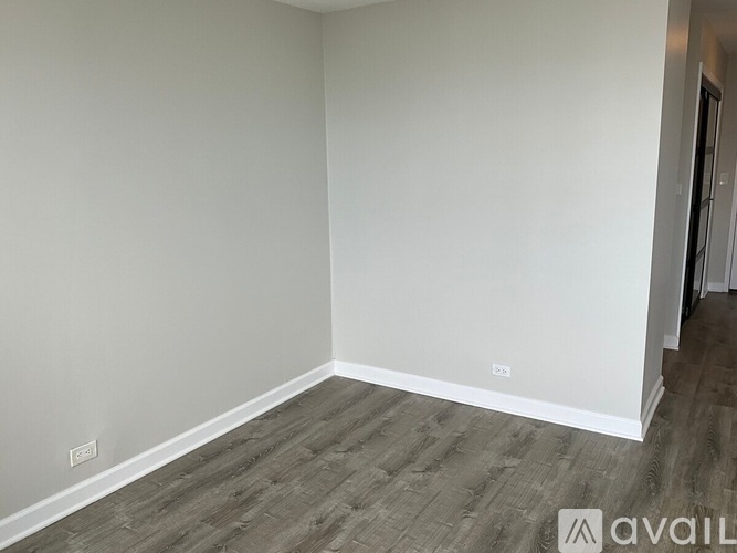 A room with a wooden floor and white walls.