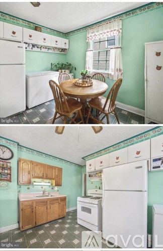 A kitchen with green walls and white appliances.