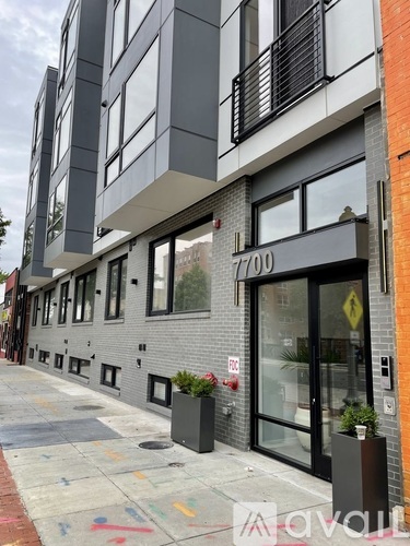 A street view of a building with the number 7700 on it.