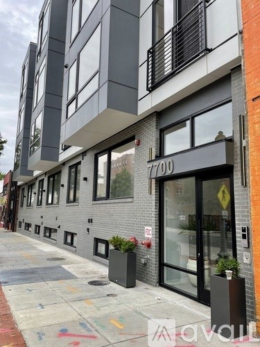 A street view of a building with the number 7700 on it.