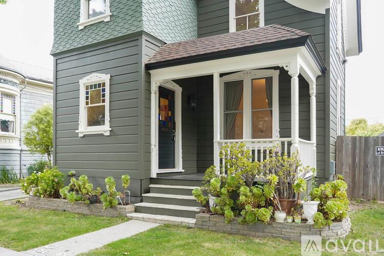 A house with a grey front porch and a white door.