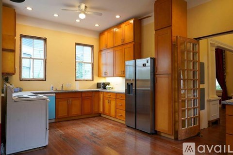 A kitchen with wooden cabinets and a refrigerator.