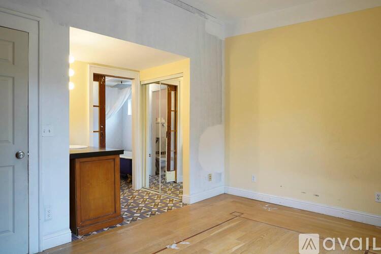 A room with a wooden cabinet and a mirror on the wall.