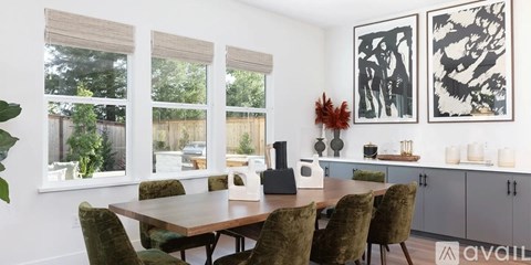 A dining room with a table and chairs.