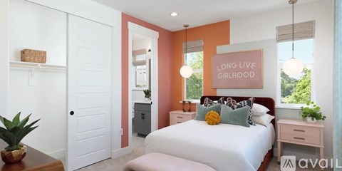 A bedroom with a white bed and a large mirror on the wall.