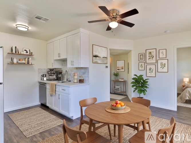 A kitchen with a table and chairs in the middle of the room.