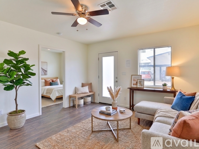 A living room with a ceiling fan and a couch.