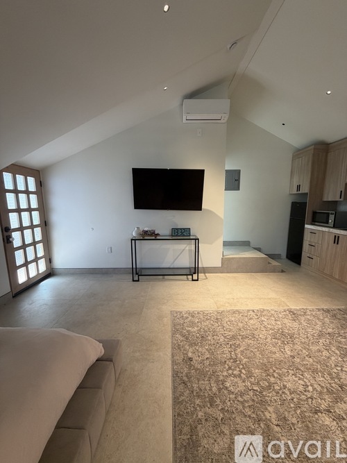 A living room with a couch and a television.