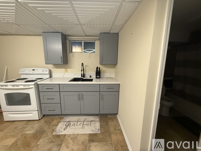 A kitchen with a white stove top oven and a white microwave.