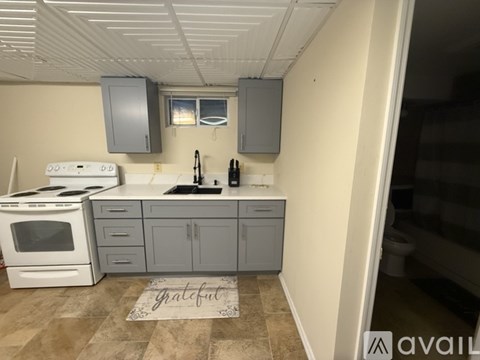 A kitchen with a white stove top oven and a white microwave.