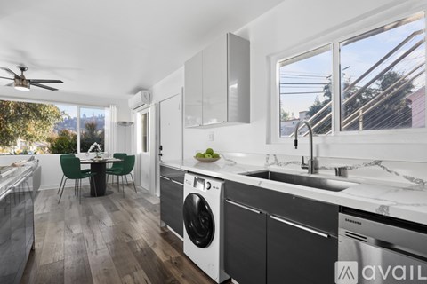 A modern kitchen with a dining table and chairs.