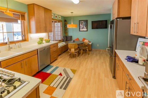 A kitchen with wooden cabinets and a stove top oven.