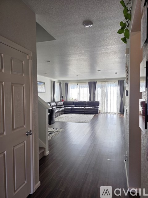 A living room with a couch and a rug.