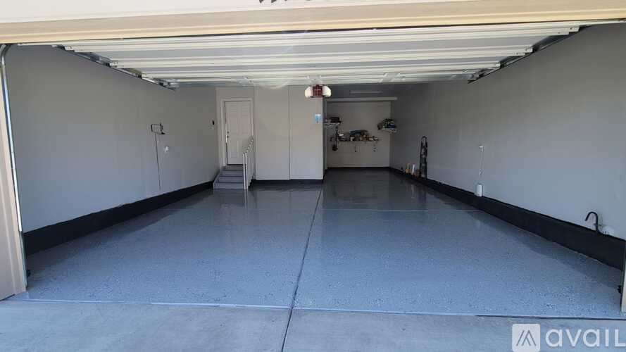 A spacious garage with a concrete floor and white walls.