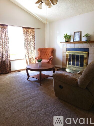 A living room with a brown chair and a brown couch.