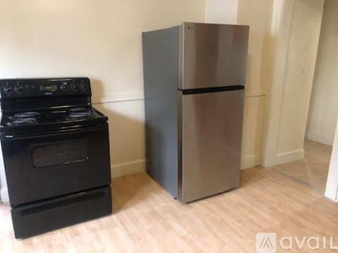A black stove and a black fridge in a room.