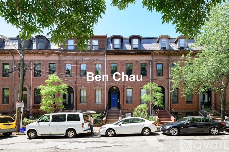 A street view of a building named Ben Chau with cars parked in front.
