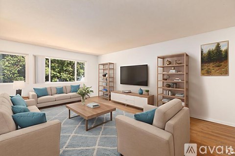 A living room with a large couch, a coffee table, and a television.