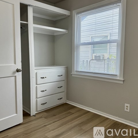 A small bedroom with a bunk bed and a dresser.