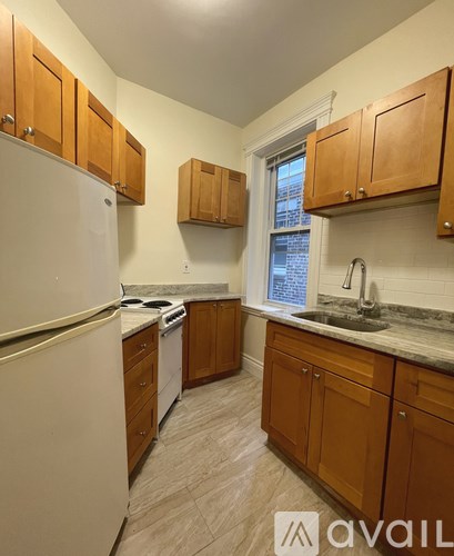 A kitchen with wooden cabinets and a white refrigerator.