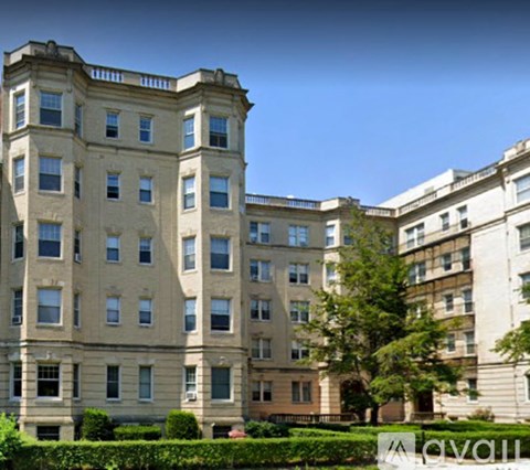 A large, beige building with many windows and balconies.