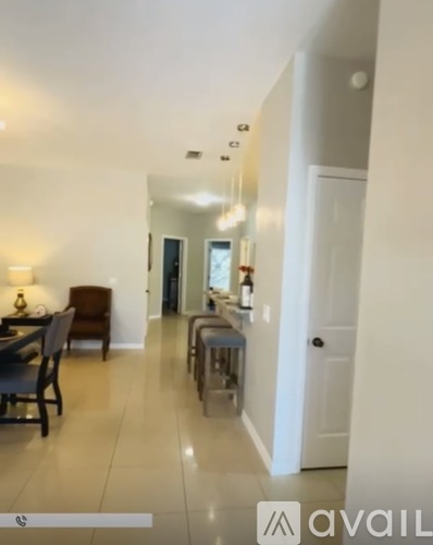 A dining room with a table and chairs is visible.