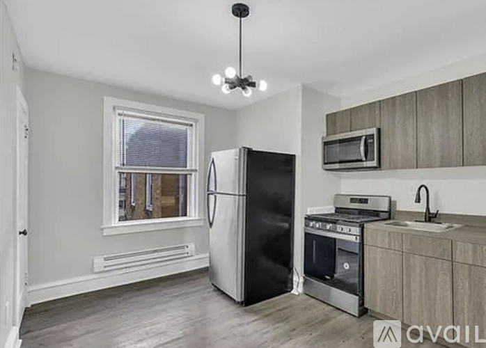 A kitchen with a black fridge, stove, and oven.
