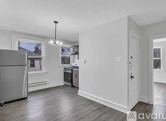 A kitchen with a refrigerator, a dishwasher, and a stove top oven.